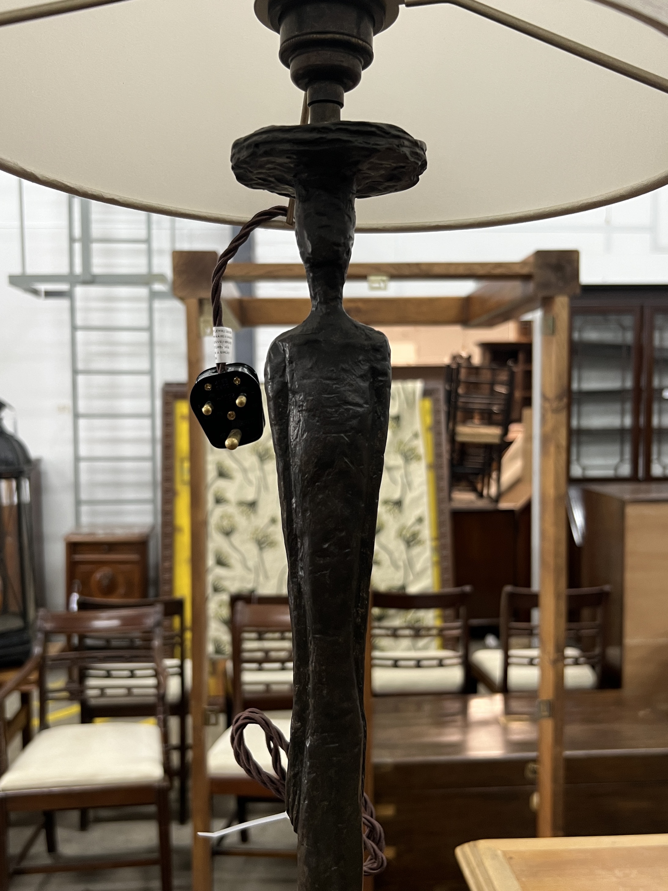A pair of contemporary bronzed resin figural table lamps and shades, height including shades 97cm